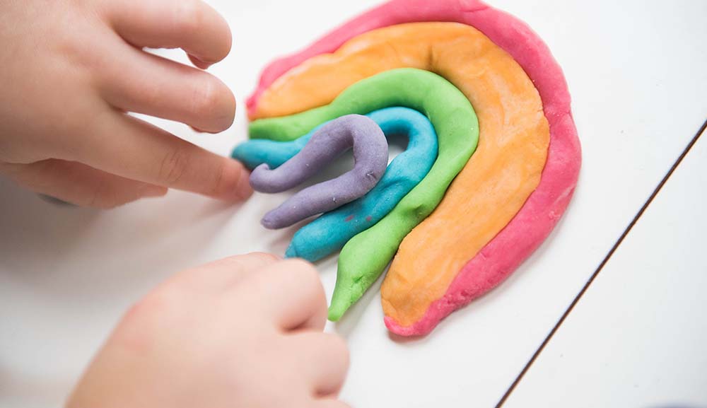 Kid playing with homemade play dough.