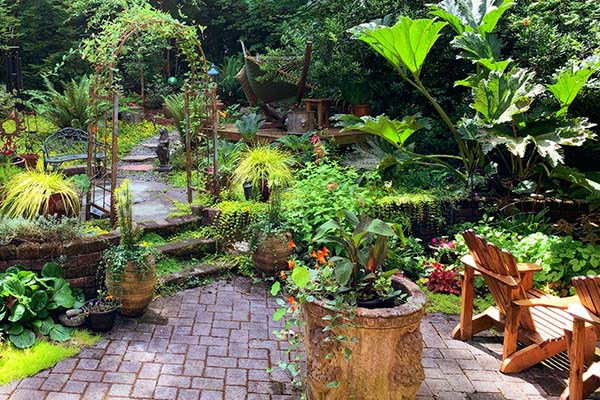 image of lavish backyard in San Francisco with pathway and leading from a sitting area through a gate